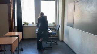 The teacher gave the test to the students and while they were doing it, the teacher was playing with her shoes