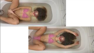 Nastya dives into the bathtub with an oval mask and plays with her hair