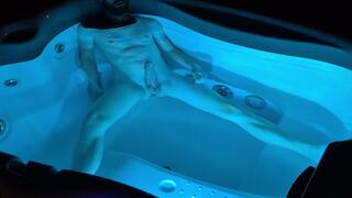 A boy takes a bath at night in a lit bathtub and gets excited