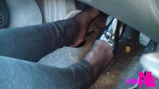Driving and revving in black buckled pumps and jeans