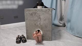 GG96-A cute barefoot Asian girl is bound inside a box, her feet sticking out from a hole and tied together. Let's tickle these beautiful feet!