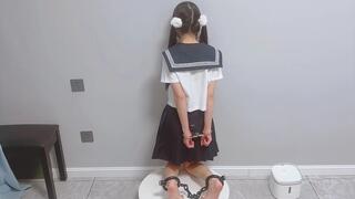 GG119-A barefoot Japanese girl with pigtails experiences traditional Chinese shackles.