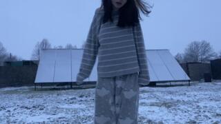 Extremely intensive shaking, skinny girl trembling from cold on the snow in pajamas