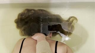 Milana's friend holds her underwater face down