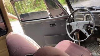 Jarlyn has trouble driving her Volkswagen Beetle on her way to work.