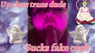 Up close trans dude sucks fake cock