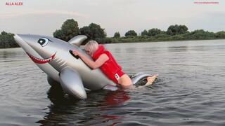 Hot sex with orgasm of a rare inflatable shark on a lake in a red inflatable safety vest