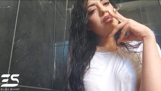 Smoking in a white wet shirt and wet hair