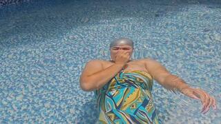 Helpless mermaid holding her breath underwater