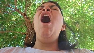 Opening her mouth in a slow yawn