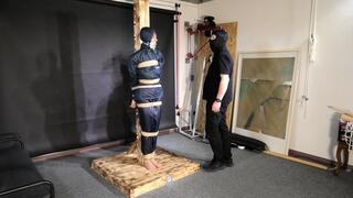 Lana tied and gagged and gagged to Post in shiny nylon Rainwear