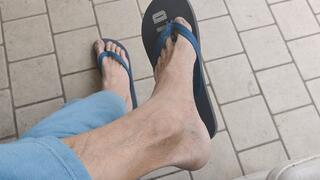 Soles, heels and shoeplay while dangling rubber flip flops