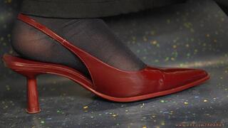 Amazing nylon feet with sexy red high heel pointed sandals, foot fetish ignoring and admiration close-up.