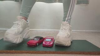Giantess Lily Kink toy car crush of Ferrari vs 1990 Cougar XR7 in big chunky trainers sneakers and stomping the bits in a box close ground view