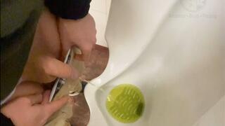 Amateur guy caught pissing in a public toilet's urinal - he then quickly plays with his cock before leaving