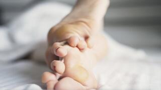 Callused feet relax in bed (720p)