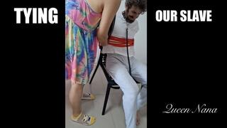 Mistresses Tying Man to Chair - 720p - Queen Nana and Mistress Poona tie their white slave boy to a chair with Shibari rope and kick him copy 1