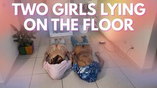 TWO GIRLS LIYING ON THE FLOOR