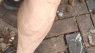 Flexing in black sneakers on cobblestone