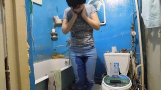 Erika is talking on the phone and pissing in her jeans