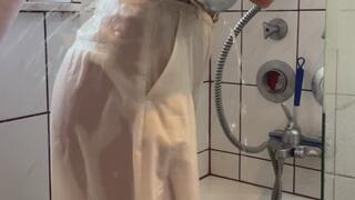 White longsleve, with beige pants in shower and bathtub