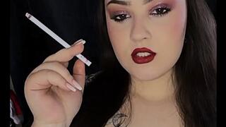 Smoking slim cigarettes with red lips
