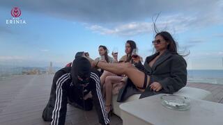 The three Mistresses humiliate the slave on the rooftop