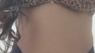 Beautiful Brazilian woman smoking a cigarette while wearing sexy lingerie.