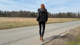 A girl in leopard shoes and nylon stockings walks on a muddy road and gets her feet dirty