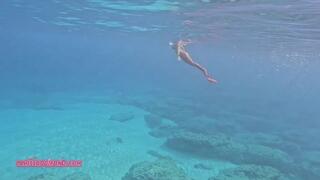 Carissa mermaiding in the Red Harlot tail in the Pacific Ocean