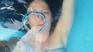 Underwater bubbles, rings and hair play wearing a blue swimsuit
