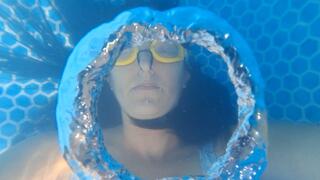Blowing rings underwater while wearing goggles