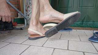 Shoeplay and dangling female flip flops and sandals