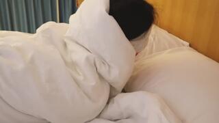 The girl in shiny white stockings in bed