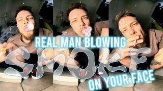 Giant straight man blowing smoke on your face