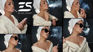 Chainsmoking two Vogue blue slim cigarettes in a bath robe