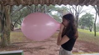 Katie Blows to Pop a Pink 16-Inch Chinese Balloon