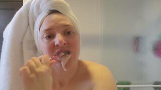 Hair up in a towel and brushing my teeth and tongue morning routine