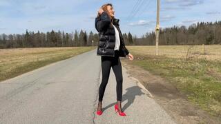 The girl in red shoes on high caboers goes on the road and comes on sticky dirt, heels stuck in this dirt, she loses her shoes on the go, pack her heels on her heels