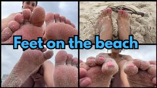 Foot worship on the beach and soles of feet with sand