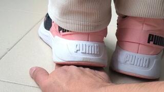 My neighbor trampling my hand with her puma sneakers
