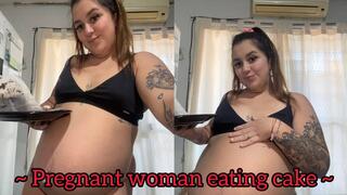 Pregnant woman eating cake + moving belly
