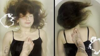 Lisa is underwater with a foot on her chest