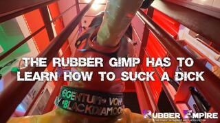 The Rubber Gimp has to learn how to suck a dick