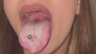 Long pierced tongue covered in thick white coat in the morning