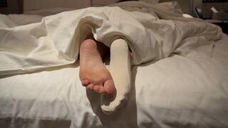 Ignoring You Listening Music - Sock Off Bare Feet Under Blanket Tease