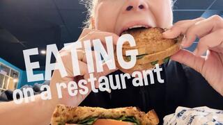Devouring a sandwich on public
