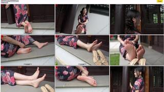 The aloof and wealthy heiress, Ren YingYing, sat on a bench, displaying her weathered, beautiful feet while wearing a long Chinese cheongsam. copy