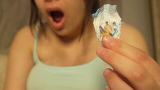 Giantess Girl unwraps a candy but is surprised because there is a tiny man in the candy bag. She is curious to see what it tastes like, so she tries it. It seems that the tiny man really annoys her, so she starts sucking it like a candy.