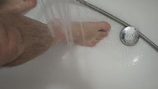 I stand in the tub and the water flows over my feet.